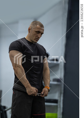 athletic man executes squats in a gym setting prioritizing technique and strength. His focus reflects dedication to fitness and physical conditioning. athletic man executes squats in a gym setting prioritizing technique and strength. His focus reflects dedication to fitness and physical conditioning. 130821658