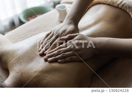 Thai massage Spa body back pain massage. Asian woman back side therapy relax treatment in spa salon. Woman happy relax skin lying spa bed use organic oil wellness body skincare. Spa salon therapist 130824228
