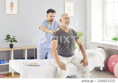 Physiotherapist Performing Back Massage For Patient During Rehabilitation Physiotherapist Performing Back Massage For Patient During Rehabilitation 130825323