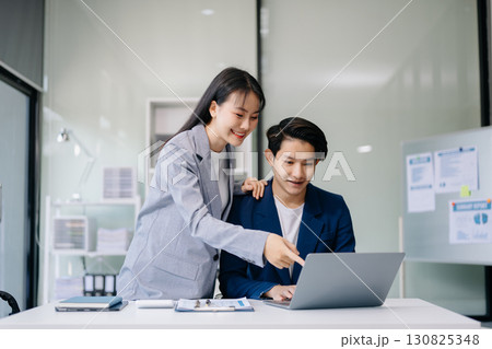 Portrait of success business people working together in office. Couple teamwork startup concept Portrait of success business people working together in office. Couple teamwork startup concept 130825348