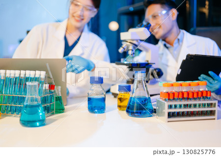 Scientist team meeting and writing analysis results in the laboratory study Scientist team meeting and writing analysis results in the laboratory study 130825776