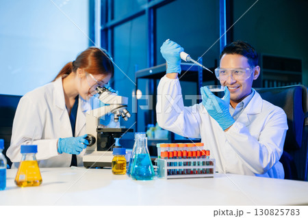 Scientist team meeting and writing analysis results in the laboratory study 130825783
