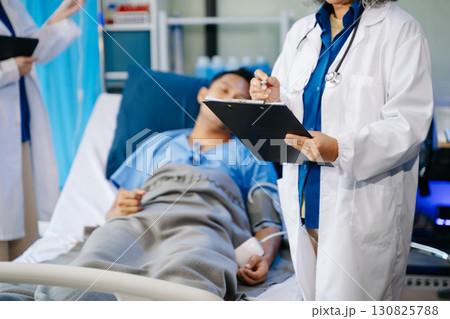 Hospital Ward Male and  Male Professional Asian Doctors Talk with a Patient, Give Health Care Advice, 130825788