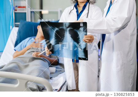 Hospital Ward Male and Male Professional Asian Doctors Talk with a Patient, Give Health Care Advice, Hospital Ward Male and Male Professional Asian Doctors Talk with a Patient, Give Health Care Advice, 130825853