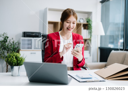 Business woman using tablet and laptop for doing math finance on an office desk, tax 130826023