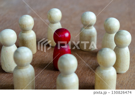 A red figurine alone against beige figurines illustrating imbalance that may reflect leadership or harassment A red figurine alone against beige figurines illustrating imbalance that may reflect leadership or harassment 130826474