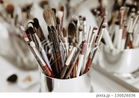 Makeup artist tools glass with brushes. Close-up Makeup artist tools glass with brushes. Close-up 130826836