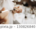 Mascara. Makeup artist takes out brush with mascara. Makeup concept, close-up 130826840