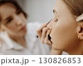 Make-up artist at work. Applying make-up to model face. 130826853