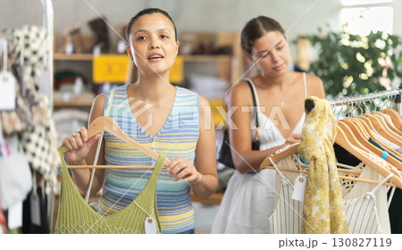 Two positive women choosing something for summer in clothing store Two positive women choosing something for summer in clothing store 130827119