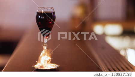 Nightlife cocktail. Drink sparkler. Red wine serving on metal saucer. Glass stem wrapping with golden party fire fiber on pub counter. 130827159