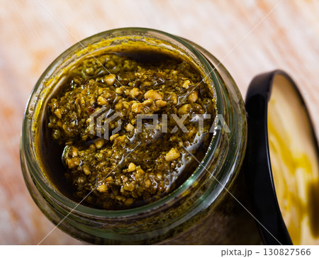 Glass jar with pesto sauce 130827566
