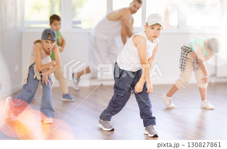 Emotional happy teen boy dancing hip hop with group of friends in dance studio. Concept hip-hop generation 130827861