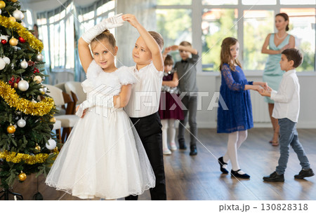 Viennese waltz performed by beautifully dressed children near Christmas tree Viennese waltz performed by beautifully dressed children near Christmas tree 130828318