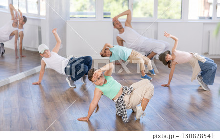 Preteen girl performing hip hop during group dance class 130828541