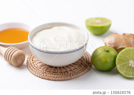 Yogurt, lime, honey and ginger on white background Yogurt, lime, honey and ginger on white background 130828576