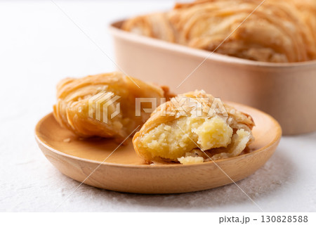 Curry puff stuffed with sweet potato on wooden plate, Thai snack food style Curry puff stuffed with sweet potato on wooden plate, Thai snack food style 130828588