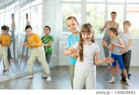 Girl paired up with boy and training to perform boogie woogie couple dance, rehearse performance. 130828681