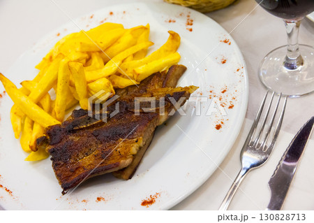 Beef steak with french fries served at plate, spanish cuisine Beef steak with french fries served at plate, spanish cuisine 130828713
