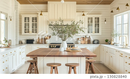 Bright White Kitchen Interior With Wooden Island And Decorative Elements And Greenery Bright White Kitchen Interior With Wooden Island And Decorative Elements And Greenery 130828840