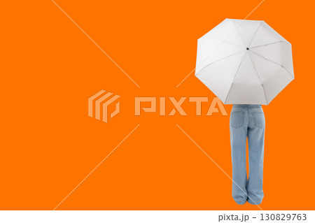 Individual stands with a white umbrella and light blue pants 130829763