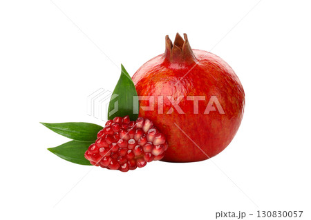 Vibrant red pomegranate with green leaves, isolated, PNG 130830057