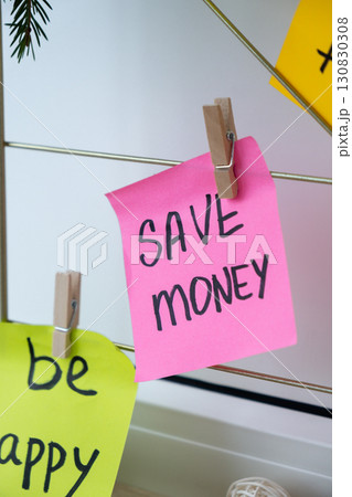SAVE MONEY financial goal on Action board new year's resolutions on colorful sticky notes. Making promises for new year, setting goals. Dream year 130830308
