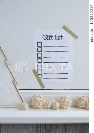 Preparation for winter holidays. GIFT LIST text on paper note. Celebration gifts and presents preparing Natural zero waste homemade Christmas decor. Happy new year Preparation for winter holidays. GIFT LIST text on paper note. Celebration gifts and presents preparing Natural zero waste homemade Christmas decor. Happy new year 130830314