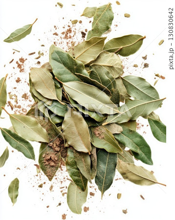 Overhead Shot of Green and Brown Bay Leaves with Brown Powder on White Background Overhead Shot of Green and Brown Bay Leaves with Brown Powder on White Background 130830642