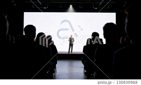 A dynamic shot of a speaker on a stage. Business presentation, keynote speech, thought leadership A dynamic shot of a speaker on a stage. Business presentation, keynote speech, thought leadership 130830988