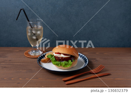 お皿にのせたテリヤキバーガー 木のテーブル 130832379