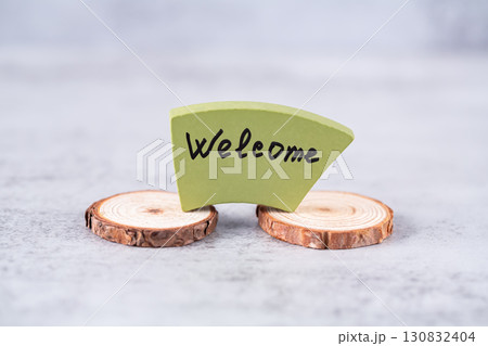 Welcome word written on green wooden board. 130832404