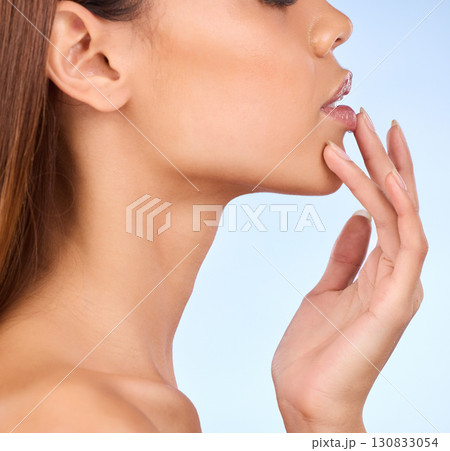 Skincare, zoom and woman with hand on lips in studio for skin or lip care promo on blue background. Makeup, facial and cosmetics, profile face of model from Brazil for dermatology or lipstick closeup Skincare, zoom and woman with hand on lips in studio for skin or lip care promo on blue background. Makeup, facial and cosmetics, profile face of model from Brazil for dermatology or lipstick closeup 130833054