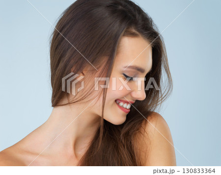 Skincare, cosmetics and woman with smile, beauty and dermatology on blue studio background. Female, lady and confidence with morning routine, grooming and luxury salon treatment, soft and smooth skin Skincare, cosmetics and woman with smile, beauty and dermatology on blue studio background. Female, lady and confidence with morning routine, grooming and luxury salon treatment, soft and smooth skin 130833364