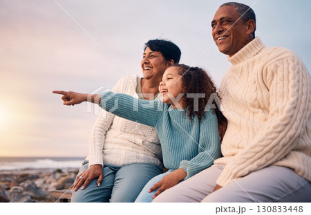Beach, black family and a girl pointing outdoor with grandparents while looking at the view together during sunset. Nature, summer or kids with a senior man and woman bonding with their grandchild Beach, black family and a girl pointing outdoor with grandparents while looking at the view together during sunset. Nature, summer or kids with a senior man and woman bonding with their grandchild 130833448