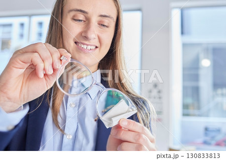 Glasses, vision and an optometrist woman cleaning lenses in a store to sell a product for fashion. Hands, eyewear and optometry with a female optician wiping a pair of frame eyeglasses for eyesight Glasses, vision and an optometrist woman cleaning lenses in a store to sell a product for fashion. Hands, eyewear and optometry with a female optician wiping a pair of frame eyeglasses for eyesight 130833813