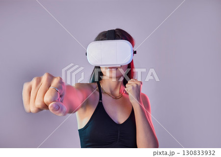 Vr, fitness and woman boxing in metaverse studio isolated on a purple background mockup. 3d exercise, virtual reality and female fighting or punching with futuristic technology for esports gaming. Vr, fitness and woman boxing in metaverse studio isolated on a purple background mockup. 3d exercise, virtual reality and female fighting or punching with futuristic technology for esports gaming. 130833932