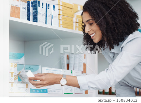 Pharmacy, medicine and product with woman reading side effects in store for healthcare, drugs dispensary and treatment prescription. Medical, pills and pharmacist check label information or shelf 130834012