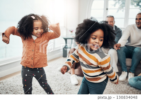 Children dancing, living room and happy family with parents, grandparents or love for comic smile in home. Kids, men and women for dance, care and happiness for brother, sister or together on holiday Children dancing, living room and happy family with parents, grandparents or love for comic smile in home. Kids, men and women for dance, care and happiness for brother, sister or together on holiday 130834048