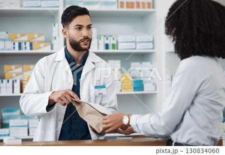 Medicine, prescription and explaining with a pharmacist man talking to a woman customer for healthcare. Medication, consulting and insurance with a male health professional working in a pharmacy Medicine, prescription and explaining with a pharmacist man talking to a woman customer for healthcare. Medication, consulting and insurance with a male health professional working in a pharmacy 130834060