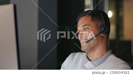 Call center, night and man in office with phone call, computer and headset in communication with smile. Telemarketing, customer service or crm, happy help desk consultant for late work for overtime. Call center, night and man in office with phone call, computer and headset in communication with smile. Telemarketing, customer service or crm, happy help desk consultant for late work for overtime. 130834381