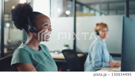 Business woman, call center and computer with happy communication, customer services and online solution. Excited african person, agent or consultant helping, talking and advice in sales at night 130834495