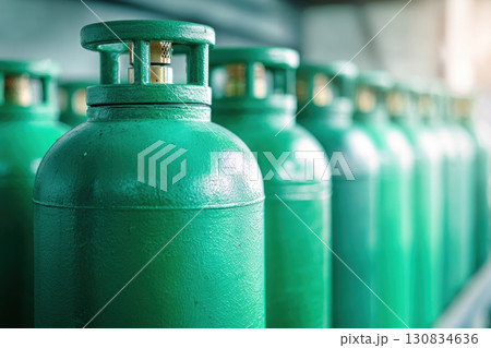 Green oxygen tanks. Bundle of gas cylinder and high pressure gauges, meter, valve. Many argon cylinders with compressed gas for industry, welding. Fuel manufacturing. Liquefied gas production, factory 130834636