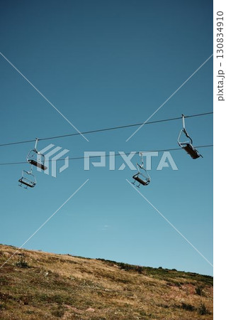 Panoramic view of Stara Planina mountains with chairlift and dry summer grassland stretching toward the horizon. Serbia country 130834910
