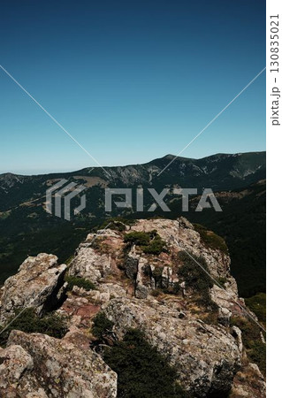 Rocky cliffs and green slopes of Stara Planina with mountain ridges in the distance. Babin Zub mount in summer season. Serbia country 130835021