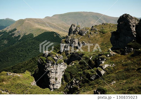 Rocky cliffs and green slopes of Stara Planina with mountain ridges in the distance. Babin Zub mount in summer season. Serbia country 130835023
