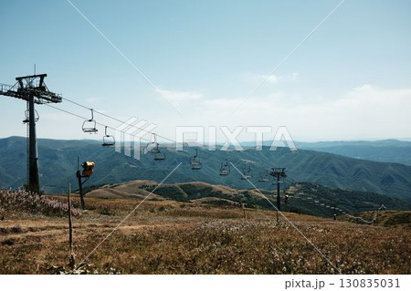 Ski lift chairs on Stara Planina mountain with panoramic view of green hills and valleys. Serbia country in summer season 130835031
