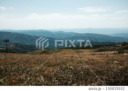 Ski lift chairs on Stara Planina mountain with panoramic view of green hills and valleys. Serbia country in summer season 130835032