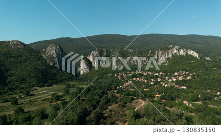 Aerial view of Jerma Canyon in Serbia with a small village surrounded by rocky cliffs and green forest 130835150
