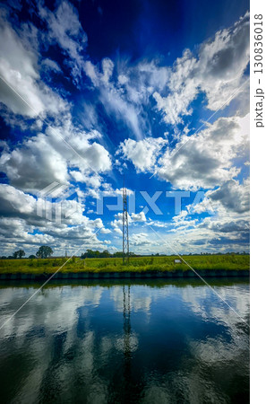 An absolutely stunning reflection of a beautifully cloudy sky over incredibly tranquil water 130836018